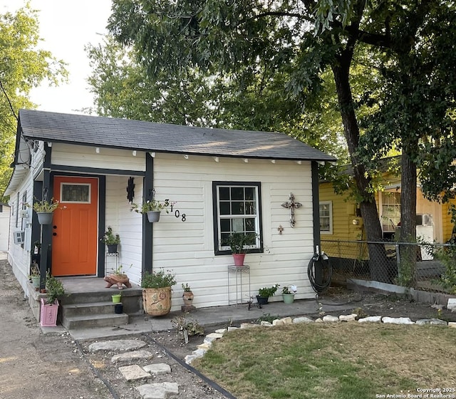 3108 Vera Cruz, San Antonio, TX 78207 - view of front of house with cooling unit, roof with shingles, and fence