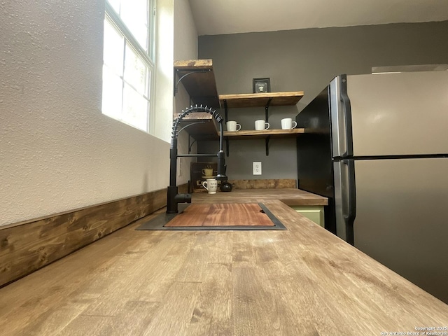 3108 Vera Cruz, San Antonio, TX 78207 - interior space with freestanding refrigerator, a textured wall, and a sink