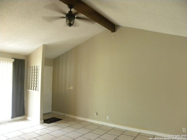 empty room with light tile patterned flooring, baseboards, vaulted ceiling with beams, a textured ceiling, and a ceiling fan