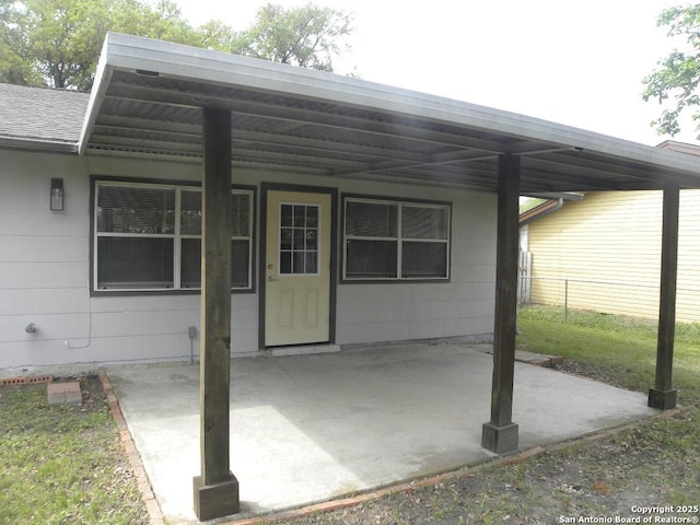 exterior space featuring fence and a carport
