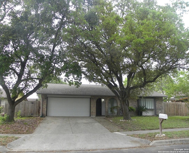 ranch-style home featuring concrete driveway, brick siding, fence, and a garage