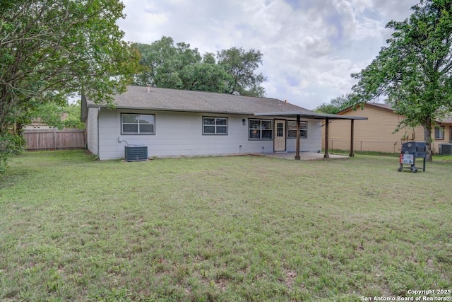 back of property featuring a yard, fence, and a patio area
