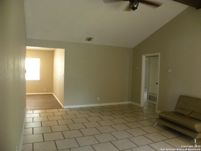 tiled empty room featuring visible vents, baseboards, ceiling fan, and vaulted ceiling