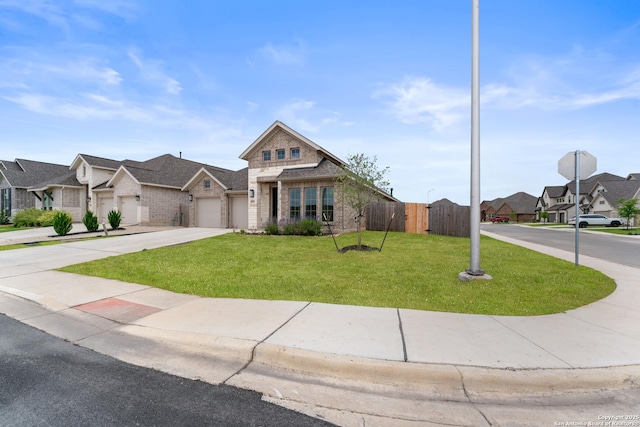 view of front of home featuring a residential view, a front lawn, driveway, fence, and an attached garage