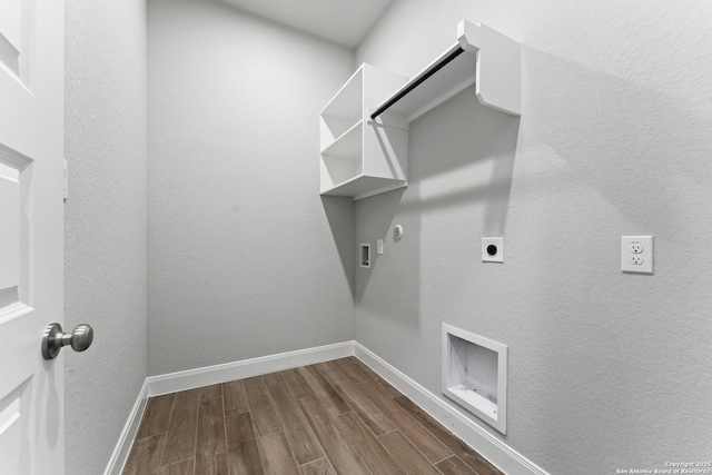 laundry area with electric dryer hookup, hookup for a gas dryer, baseboards, dark wood-type flooring, and laundry area
