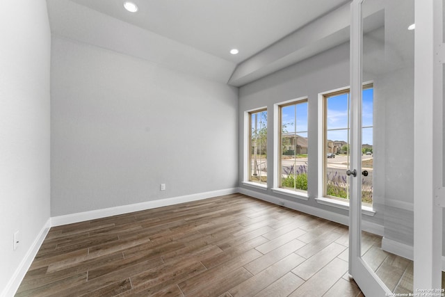 empty room with baseboards, recessed lighting, and dark wood-style flooring