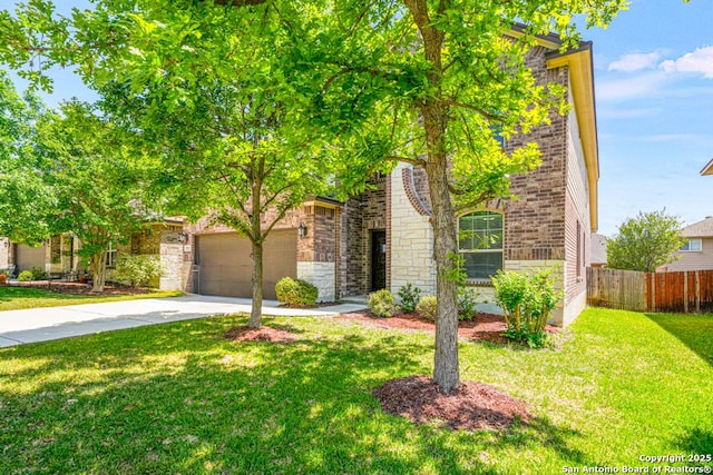 view of property hidden behind natural elements featuring a front lawn, driveway, fence, brick siding, and a garage