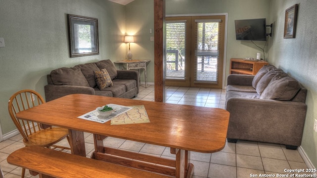 living area featuring a wealth of natural light, french doors, and light tile patterned floors