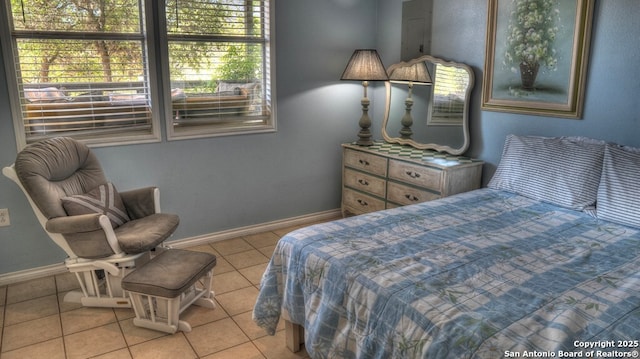 bedroom with tile patterned flooring and baseboards