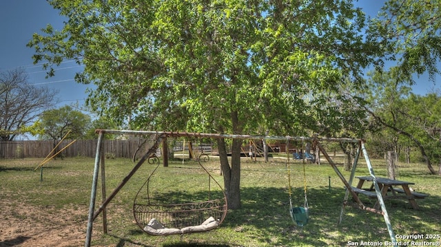view of play area with fence and a yard