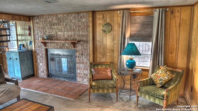 living area featuring wooden walls, a fireplace, and carpet floors