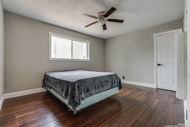 bedroom featuring wood finished floors, baseboards, and ceiling fan