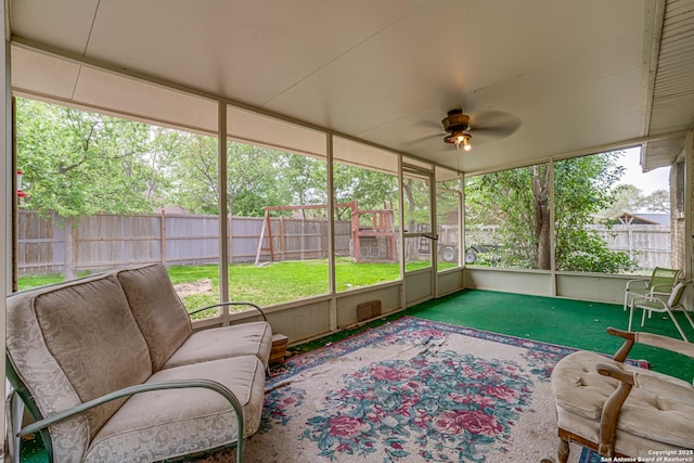 sunroom / solarium with an outdoor living space and a ceiling fan