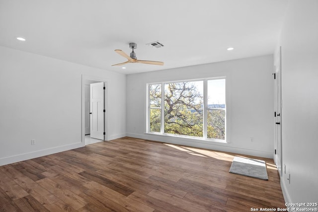 empty room with recessed lighting, wood finished floors, visible vents, baseboards, and ceiling fan