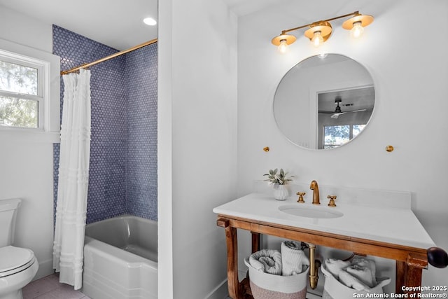 bathroom featuring toilet, vanity, and shower / bathtub combination with curtain