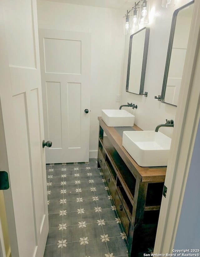 full bath with double vanity and a sink