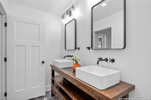 full bath featuring a sink, recessed lighting, and double vanity