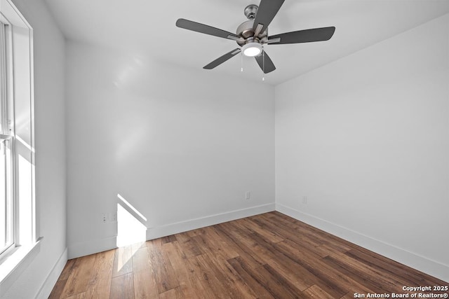 spare room with baseboards, a ceiling fan, and wood finished floors