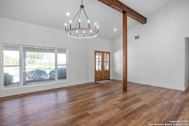 interior space featuring an inviting chandelier, wood finished floors, visible vents, beamed ceiling, and high vaulted ceiling