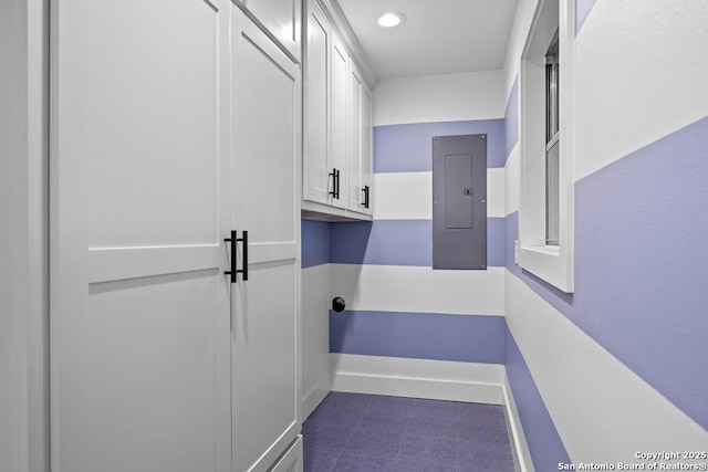 laundry room with electric panel and recessed lighting