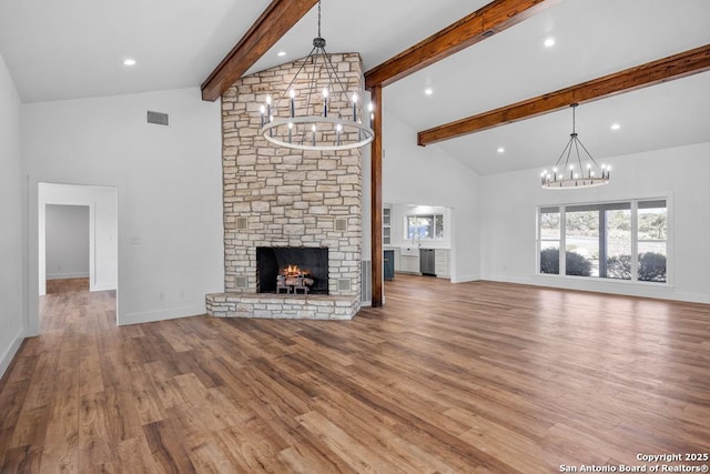 unfurnished living room featuring visible vents, an inviting chandelier, and high vaulted ceiling