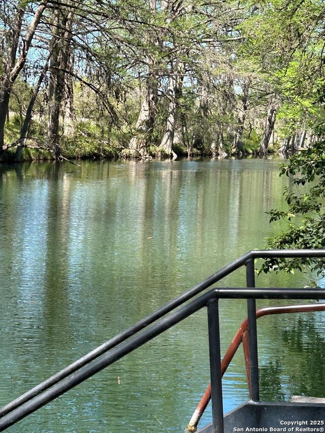 dock area featuring a water view and a balcony