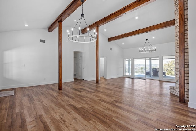 unfurnished living room featuring baseboards, visible vents, a chandelier, beamed ceiling, and high vaulted ceiling