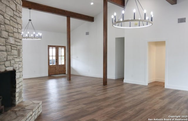 unfurnished living room featuring beamed ceiling, visible vents, high vaulted ceiling, and an inviting chandelier