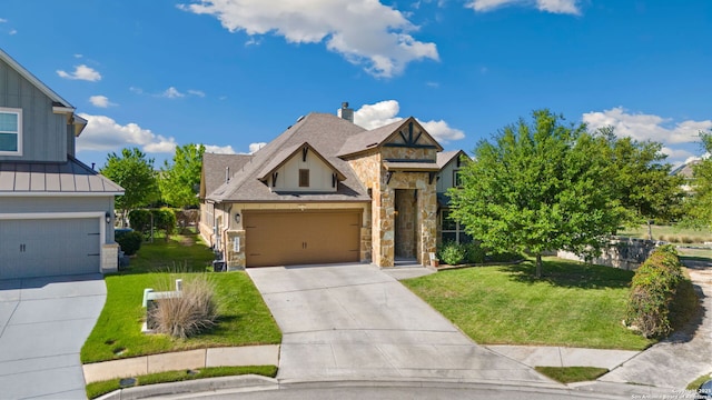 view of front facade with a garage, stone siding, a front lawn, and concrete driveway