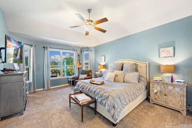 carpeted bedroom with baseboards and a ceiling fan