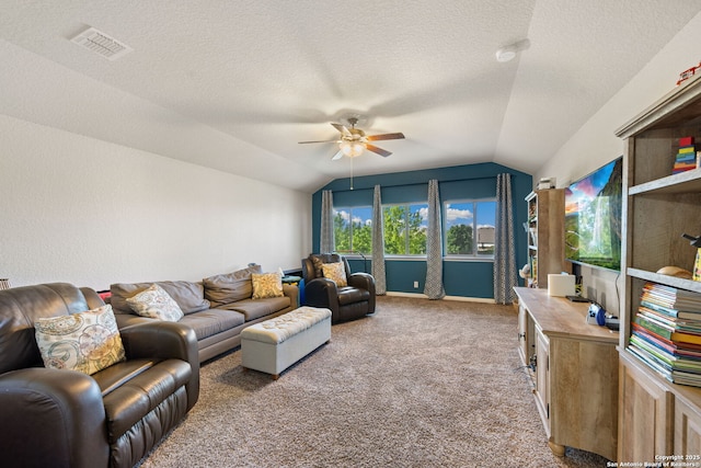 living area featuring a textured ceiling, vaulted ceiling, visible vents, ceiling fan, and carpet floors