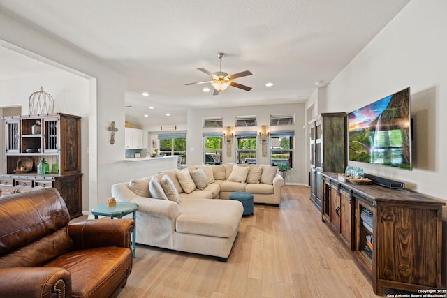 living area with recessed lighting, light wood finished floors, and a ceiling fan
