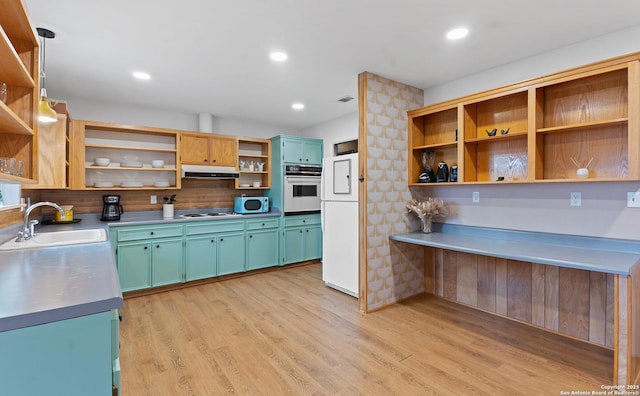 kitchen with a sink, light wood-type flooring, white appliances, open shelves, and under cabinet range hood