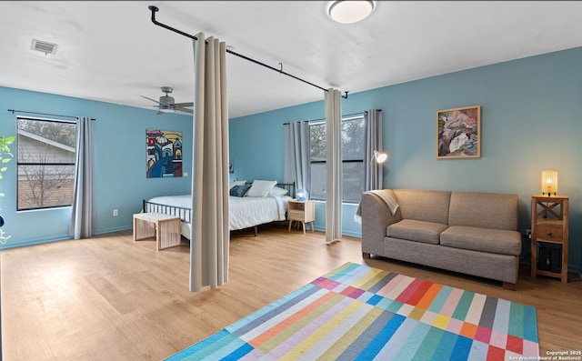 bedroom featuring wood finished floors and visible vents