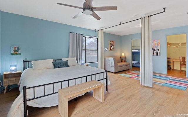 bedroom with ceiling fan and light wood-style flooring