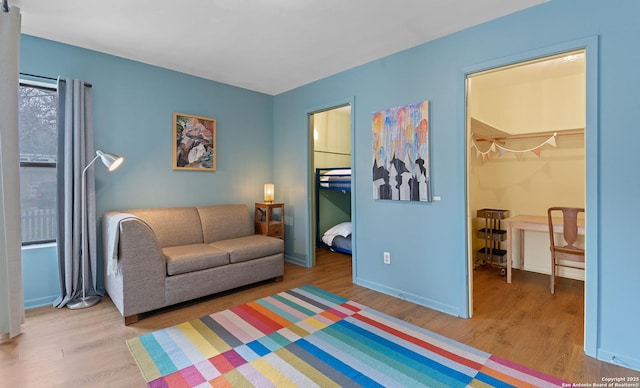 living area featuring baseboards and wood finished floors