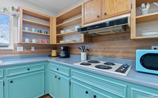 kitchen with white electric cooktop, under cabinet range hood, open shelves, and light countertops