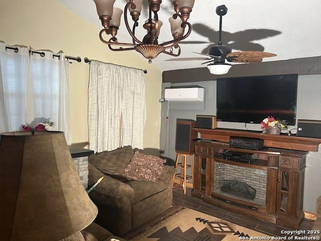 404 W Polk, Sabinal, TX 78881 - living room with wood finished floors, an AC wall unit, and a ceiling fan