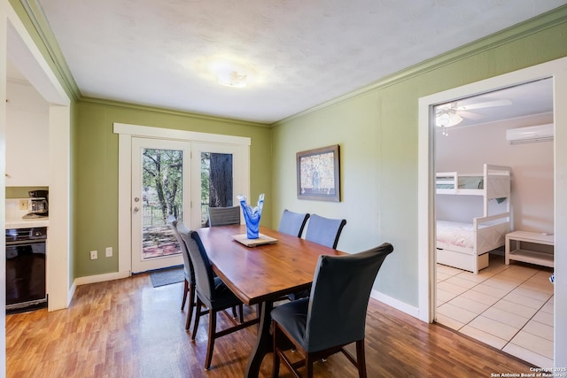 706 Gloria, Seguin, TX 78155 - dining room featuring a wall mounted air conditioner, wood finished floors, a ceiling fan, crown molding, and baseboards