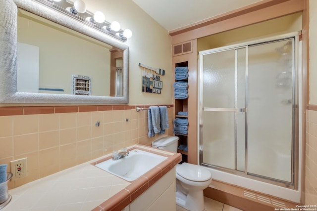 706 Gloria, Seguin, TX 78155 - bathroom with a shower stall, vanity, tile walls, toilet, and visible vents