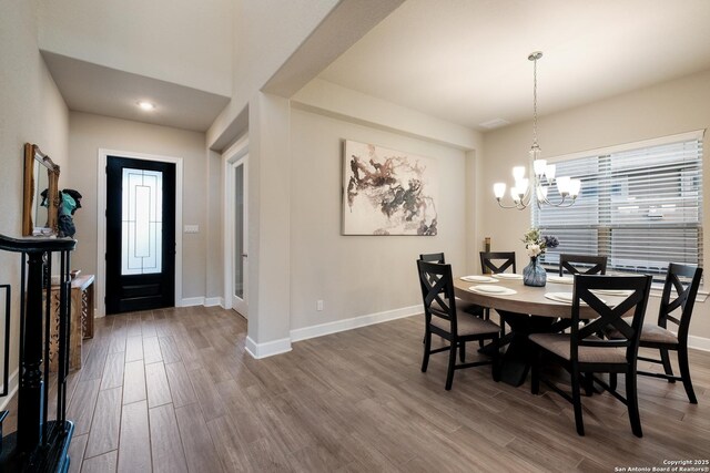 16106 Salto Del Agua, San Antonio, TX 78255 - dining area featuring plenty of natural light, baseboards, wood finished floors, and an inviting chandelier