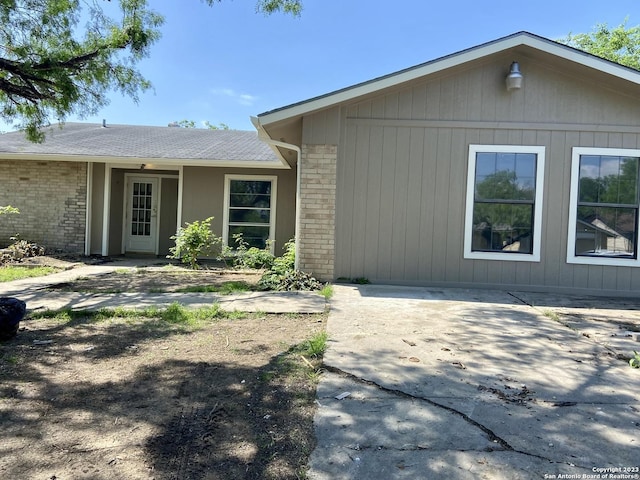 single story home with brick siding and a patio area