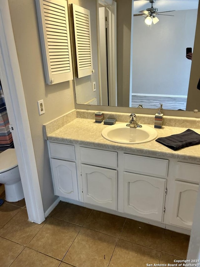 bathroom featuring toilet, a ceiling fan, vanity, and tile patterned floors