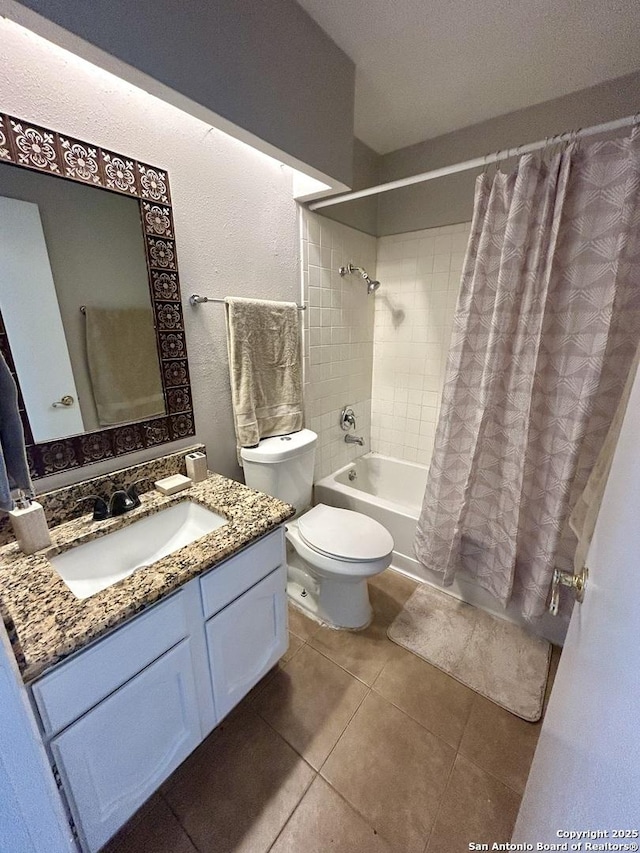 full bath featuring tile patterned floors, shower / bath combination with curtain, vanity, and toilet
