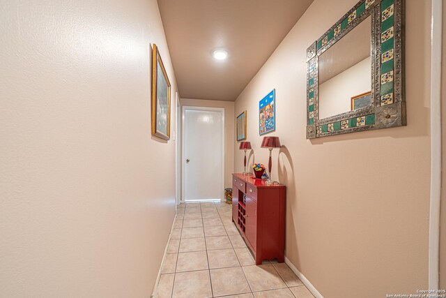 hall with recessed lighting, baseboards, and light tile patterned floors