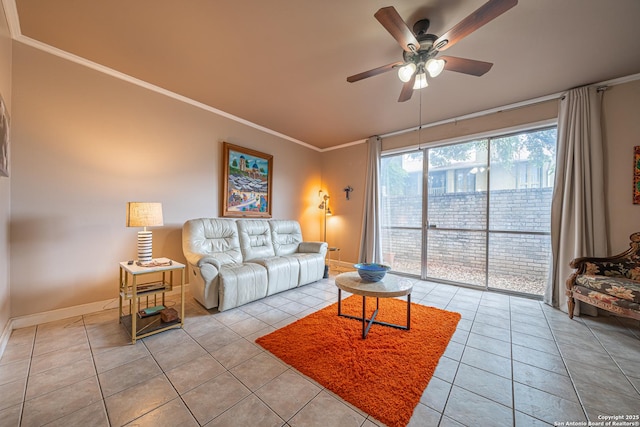 living area with a ceiling fan, baseboards, ornamental molding, and light tile patterned flooring