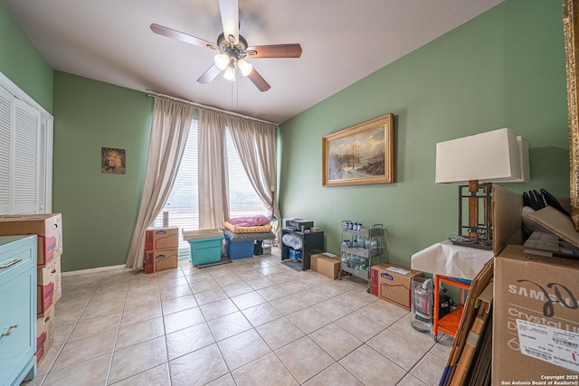 interior space with ceiling fan and light tile patterned flooring