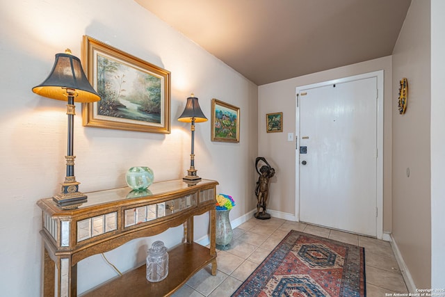 foyer entrance with baseboards and light tile patterned floors