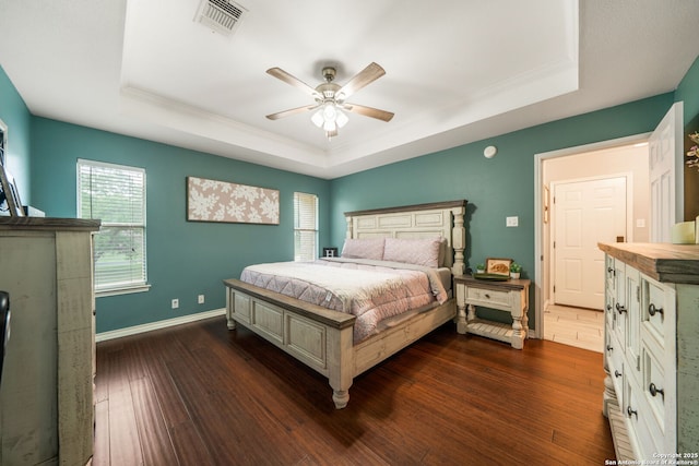 170 Pullman Rd, La Vernia, TX 78121 - bedroom with a tray ceiling, dark wood-style floors, visible vents, baseboards, and a ceiling fan