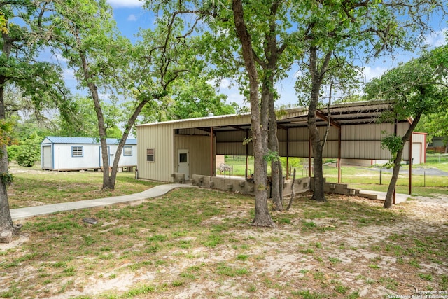 170 Pullman Rd, La Vernia, TX 78121 - exterior space featuring an outdoor structure, an outbuilding, and a detached carport